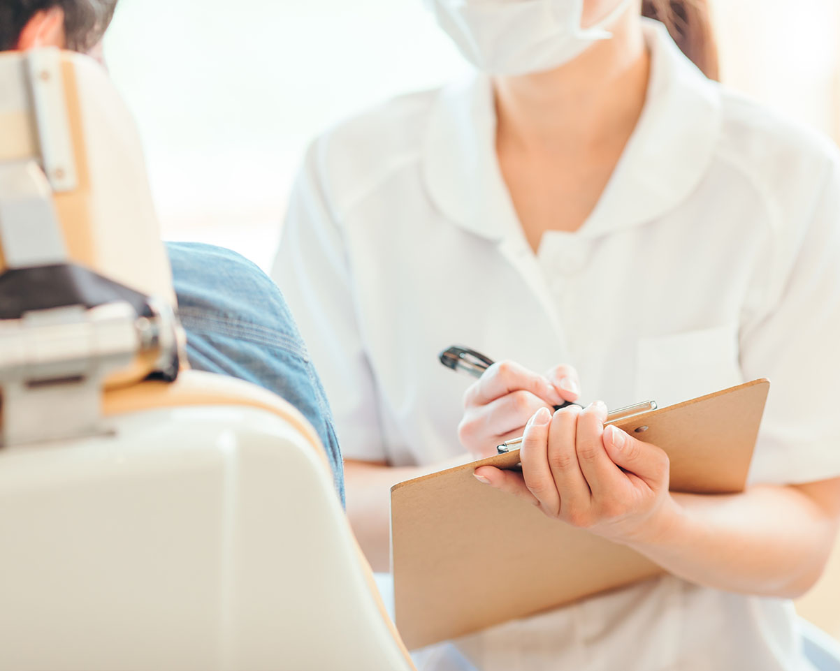 A woman with curly hair is seen applying makeup in front of a mirror.